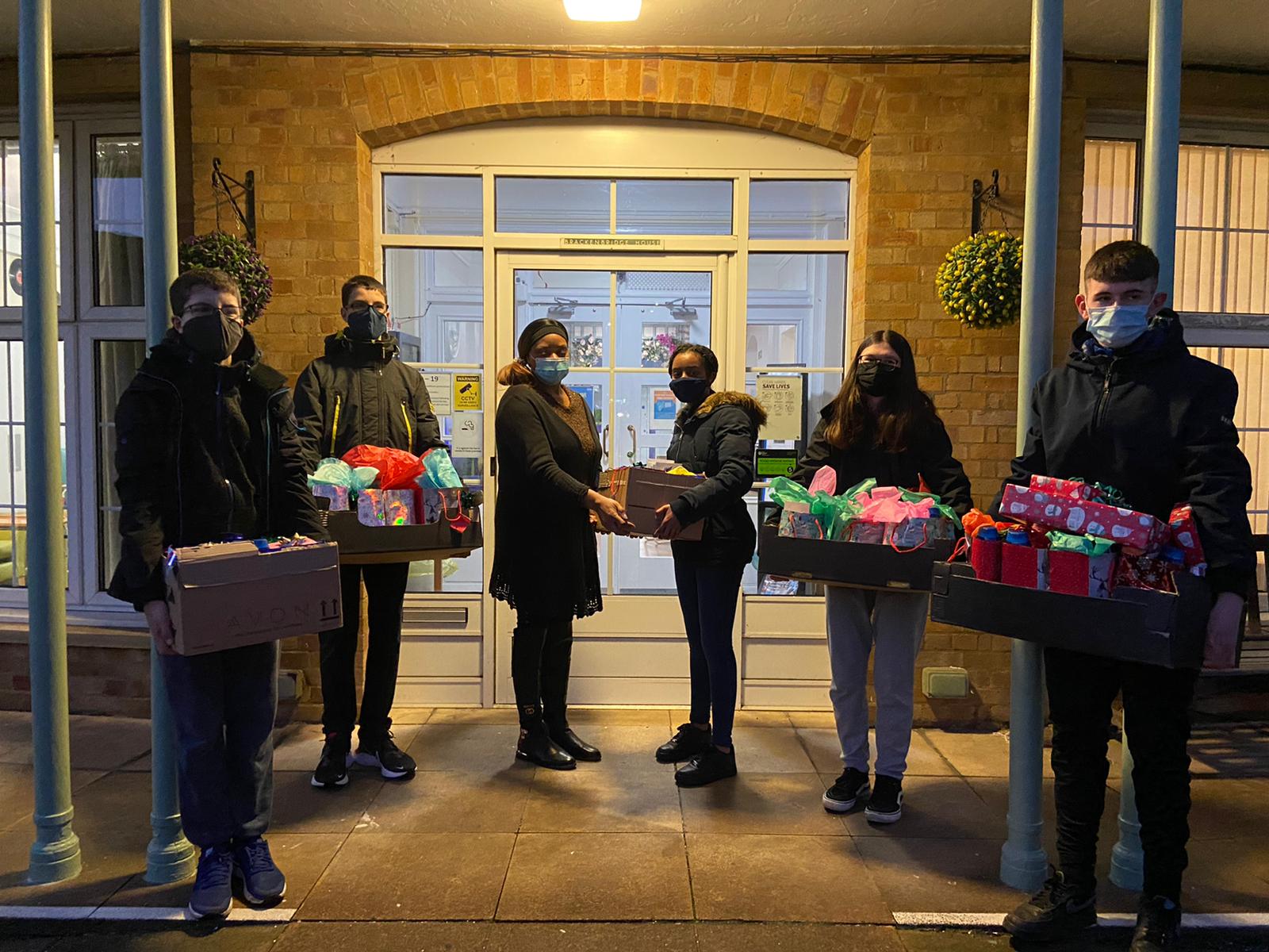Young Persons SVP presenting the gifts they wrapped to the Brackenbridge Care Home.